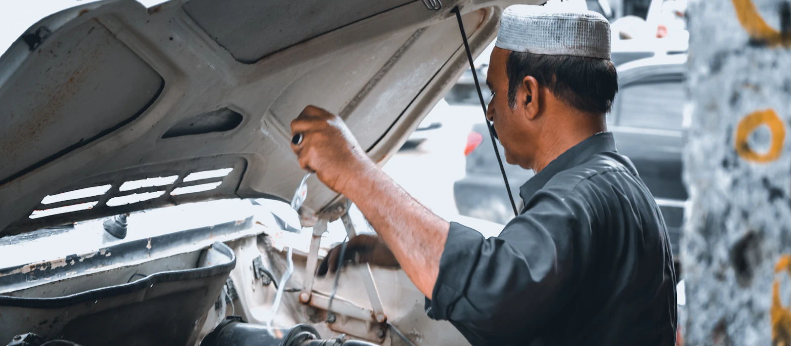 Auto electrician repairing a vehicle in a Perth workshop